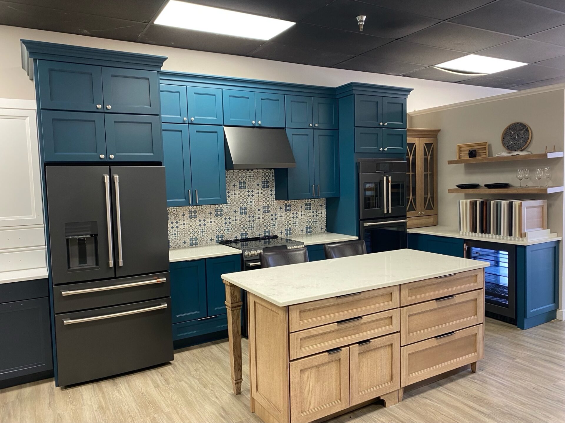 bright blue kitchen cabinets white neutral wooden island showroom