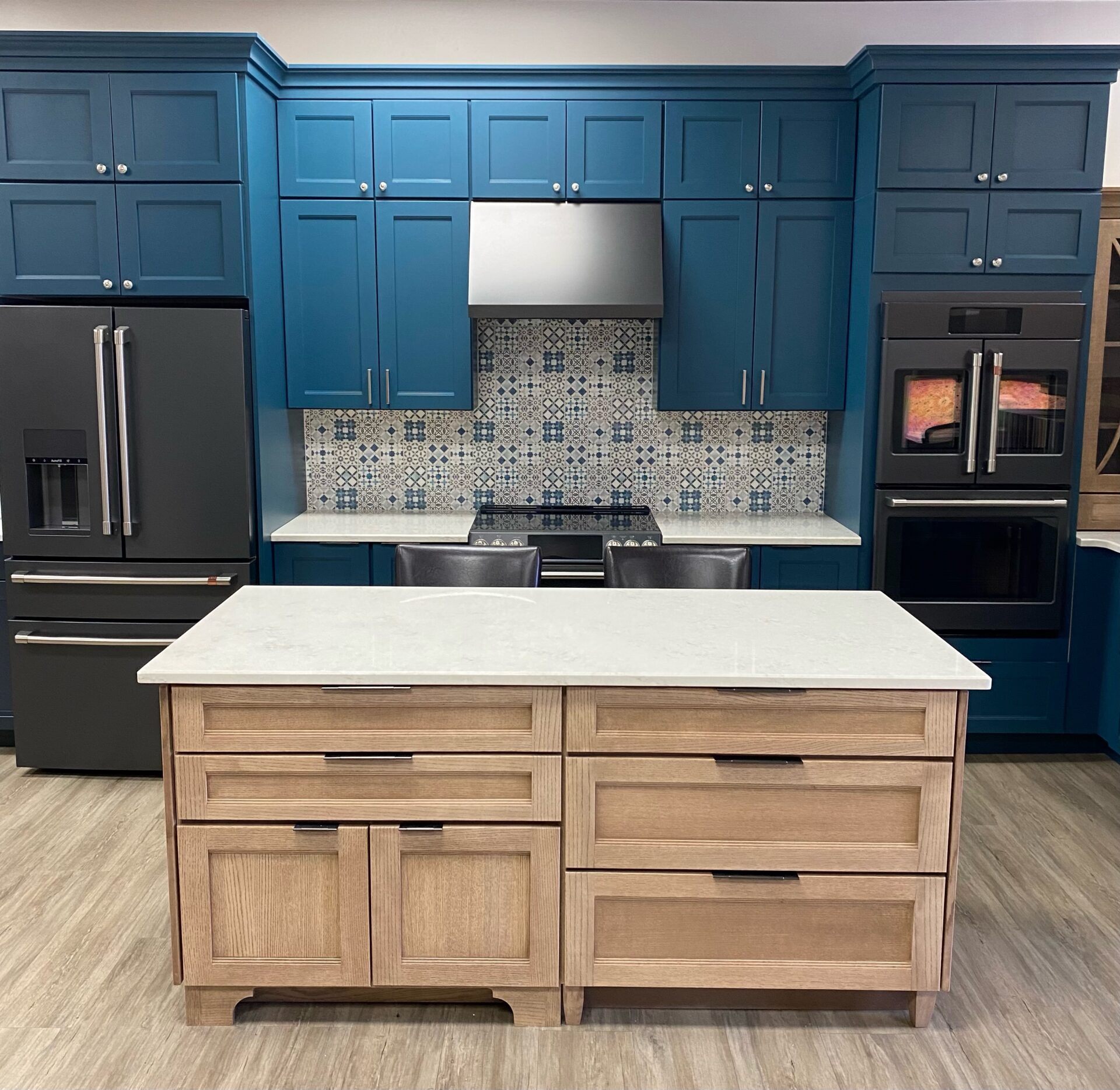 bright blue kitchen cabinets white neutral wooden island showroom