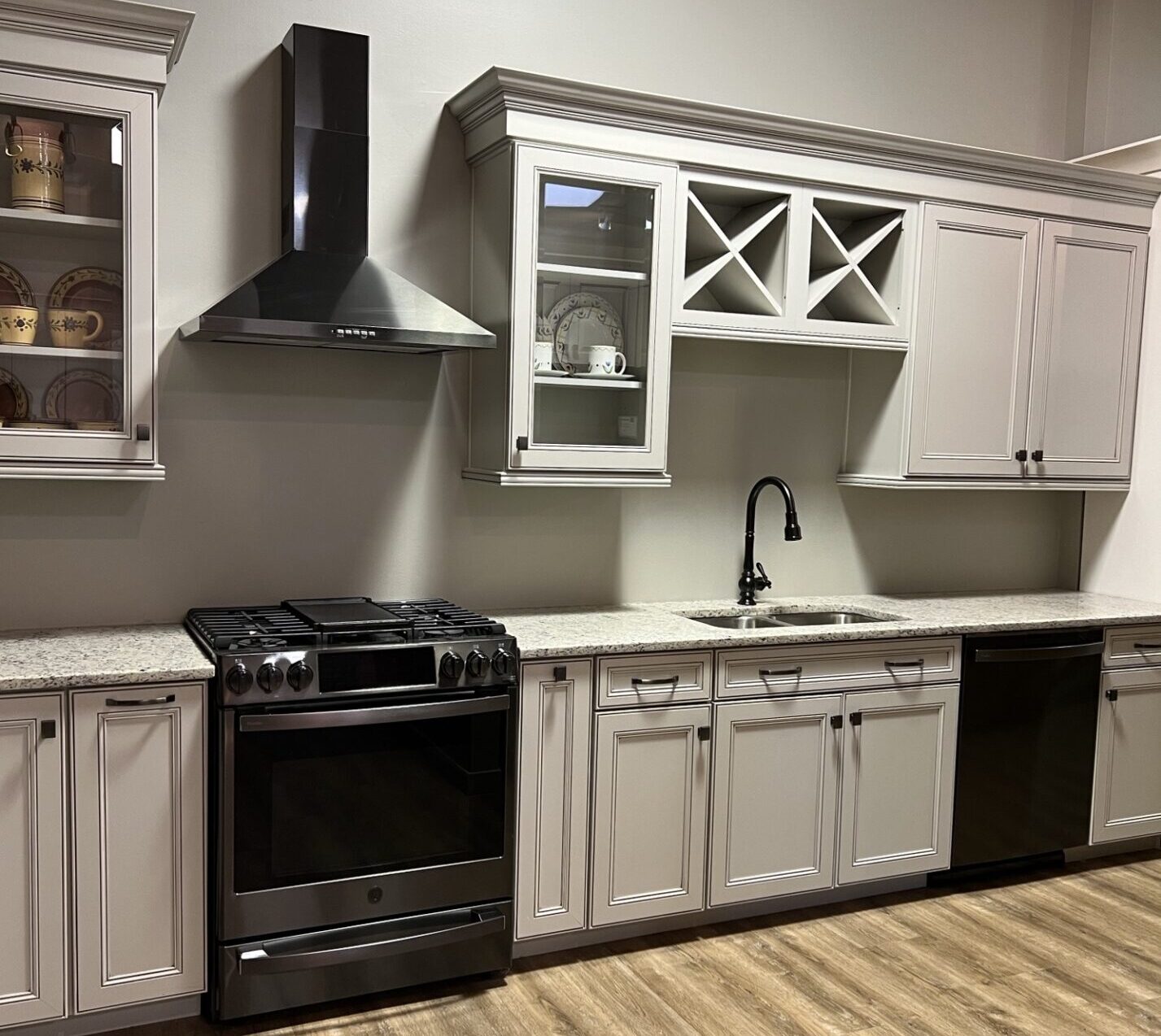 BKT Wilmington De Showroom aged white cabinets, white countertops, and gray appliances