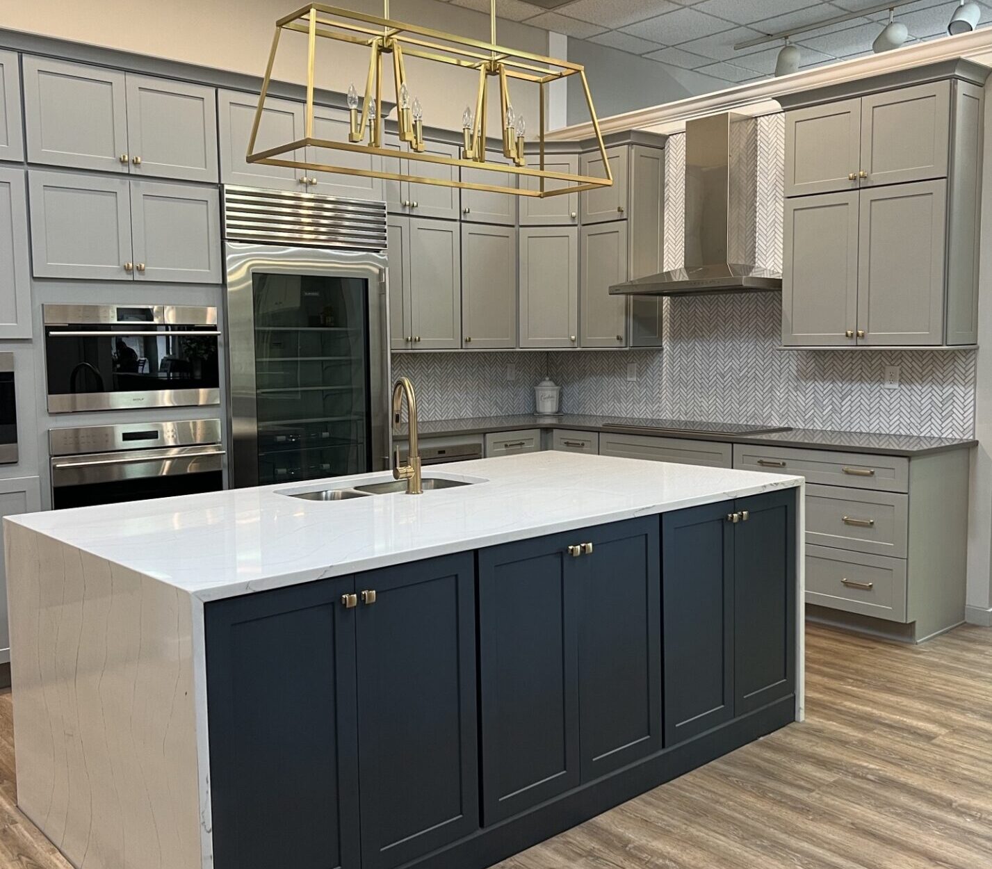 BKT Wilmington De Showroom kitchen with navy island and gray cabinets